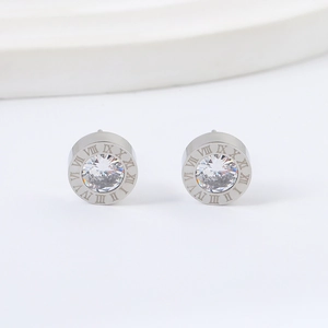Detailed close-up of silver Roman numeral stud earrings with a sparkling center zircon