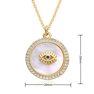 Detail shot of 20mm golden Evil Eye pendant with mother of pearl and white zircons
