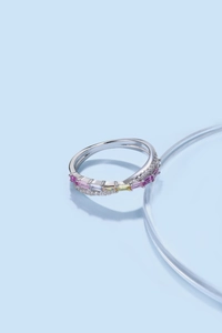 Macro shot of silver ring with colorful rectangular gems and white pavé cubic zirconia