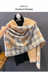 Detail of plaid and floral pattern cashmere-like scarf with fringe edges and warm tones