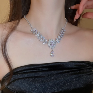Detail of silver wheat ear and floral necklace with zircon water drop pendant on model