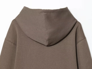 Detail view of the heavy taupe cotton fabric and clean hood design on the tracksuit set