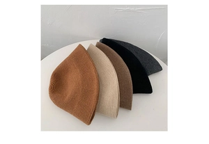 Stacked collection of knitted bucket hats in caramel, beige, brown, black and grey tones