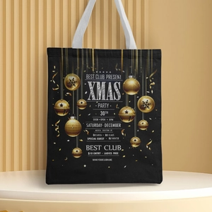 Detail view of black Christmas tote bag with gold festive print on a circular pedestal