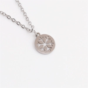 Polished stainless steel snowflake pendant necklace with minimalist silver cutout design