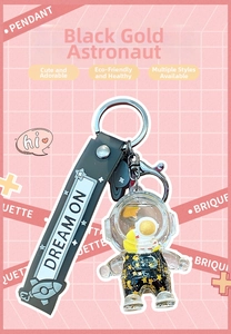 Detail of astronaut liquid keychain with gold stars, lobster clasp and silicone strap