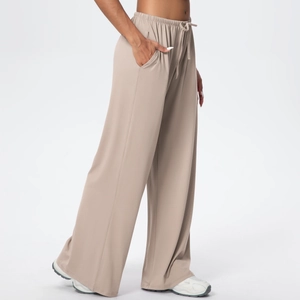 Close-up of khaki wide-leg casual pants showing drawstring waistband and side pockets