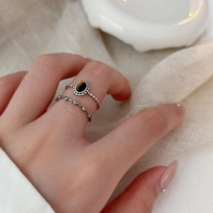 Macro detail of retro S925 silver ring featuring oval tiger eye stone and floral engraving