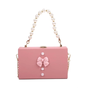 Chic pink box handbag with pearl handle and large bow detail for stylish women