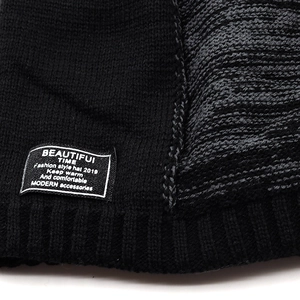 Close-up of ribbed knit winter beanie with stitched fashion tag and gray-black textures