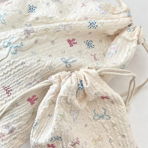 Detail of bunny star pattern on textured cream drawstring cotton storage bags