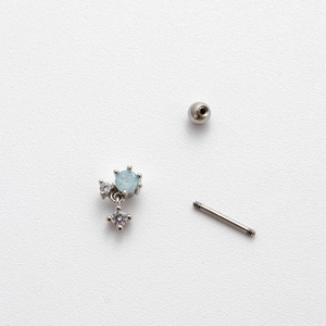 Detailed view of 20G stainless steel ear stud parts with blue and clear zircon gems
