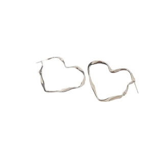 Minimalist silver irregular heart-shaped hoop earrings with a modern geometric design
