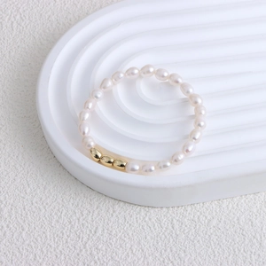 Elegant white freshwater pearl bracelet with 14K gold beads and minimalist luxury design