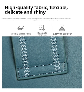 Close-up of premium soft leather texture with precision double-row stitching on women's bag