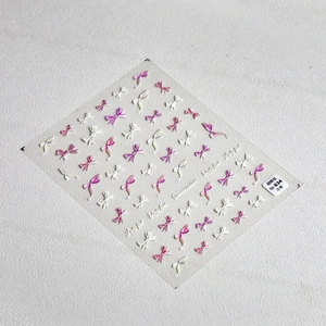 Macro detail of 3D embossed pink and white bow nail art stickers model to 634
