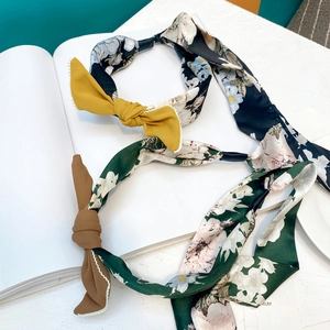 Detail of floral fabric headbands with bow accents and braided texture design