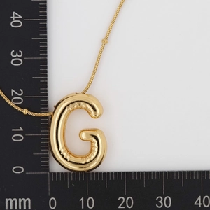 Detailed size measurement of a gold puffer G letter pendant with beaded snake chain