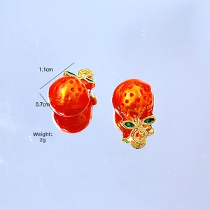 Close-up of orange fruit charms with green leaves and dimensions 1.1cm x 0.7cm