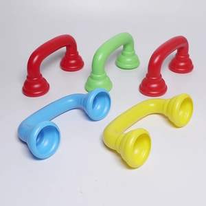 Macro view of colorful plastic toy handsets in red, green, blue and yellow on white