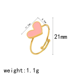 Detail view of pink enamel heart ring with measurements: 11.7mm width and 1.1g weight