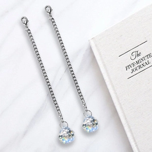 Silver chain accessory with iridescent crystal sphere pendant and lobster clasp detail