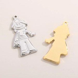 Macro detail of punk hip hop rock boy pendants in silver and gold polished finish