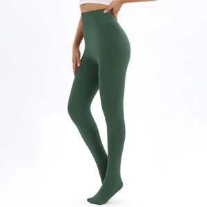 Detail view of dark green high-waisted thermal leggings with a sleek matte finish