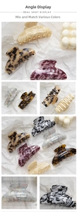 Close-up of large acetate claw clips in leopard, marble, and tortoiseshell patterns
