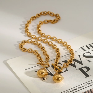 Detail of 18k gold plated titanium steel necklace with irregular ball pendant and OT buckle