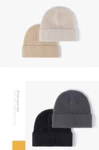 Close-up of soft fluffy knit beanie textures in beige khaki gray and black colors