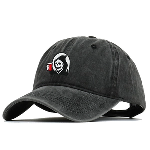 Detail of vintage washed black baseball cap featuring grim reaper embroidery design