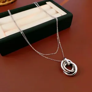 Silver interlocking triple ring pendant necklace with zircon on a cross chain