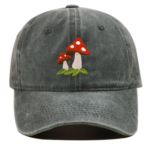 Detailed view of red mushroom embroidery on charcoal washed cotton baseball cap