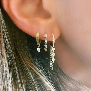 S925 silver needle drop earrings set with gold and silver zircon inlay on model
