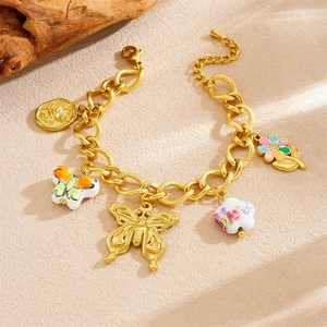 Gold-plated charm bracelet with ceramic floral pendants and a butterfly charm for women
