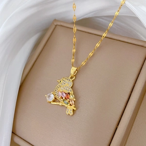 Detailed close-up of bird pendant necklace with sparkling colorful zircon stones