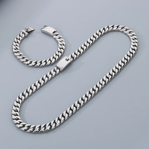 Detail view of 12mm silver stainless steel Cuban chain necklace and bracelet set for men