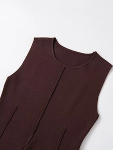 Detail of dark brown knit vest showing the ribbed neckline and premium fabric texture