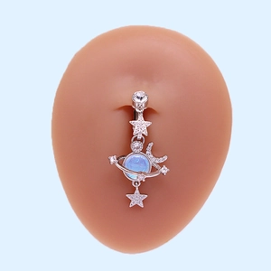 Silver belly button ring with star, moon and blue planet pendant on skin model
