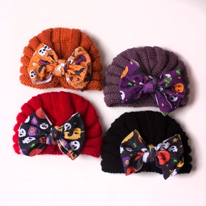 Set of 4 ribbed knit baby beanies featuring festive Halloween pumpkin and bat bow details