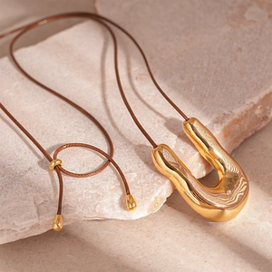 Minimalist gold U-shaped liquid metal pendant necklace with adjustable brown cord