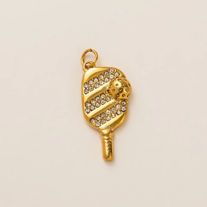 Detail shot of a 18k gold plated pickleball paddle pendant with sparkling crystal rhinestones
