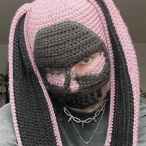 Close-up of pink and black crochet bunny balaclava showing long ears and woven texture