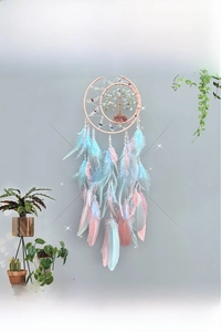 Macro detail of dream catcher featuring moon tree of life with crystal stones and pink feathers
