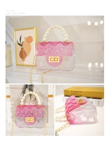 Macro view of gradient jelly bag featuring pearl handle and golden chain details