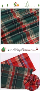 Close-up of red and green plaid fabric with Merry Christmas texture for gift wrapping