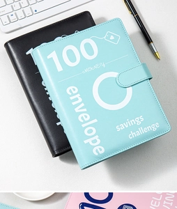 Flat lay of light blue and black PU leather 100 envelope savings challenge binders