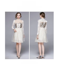 Detail of white lace mesh dress featuring floral embroidery and sheer long sleeves