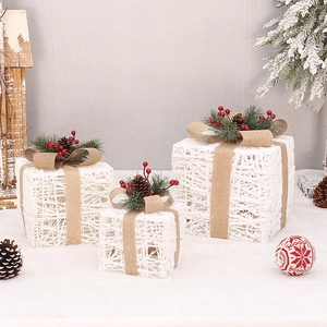 Three-piece set of white rattan Christmas gift boxes with pine cones and burlap bows